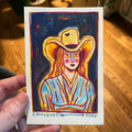 colorful watercolor painting of a woman wearing a cowboy hat by artist CJ Hughes